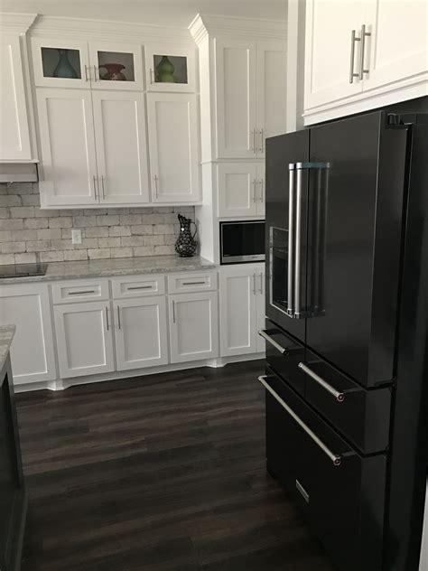 black stainless steel appliances white cabinets black hardware|black fridge in white kitchen.